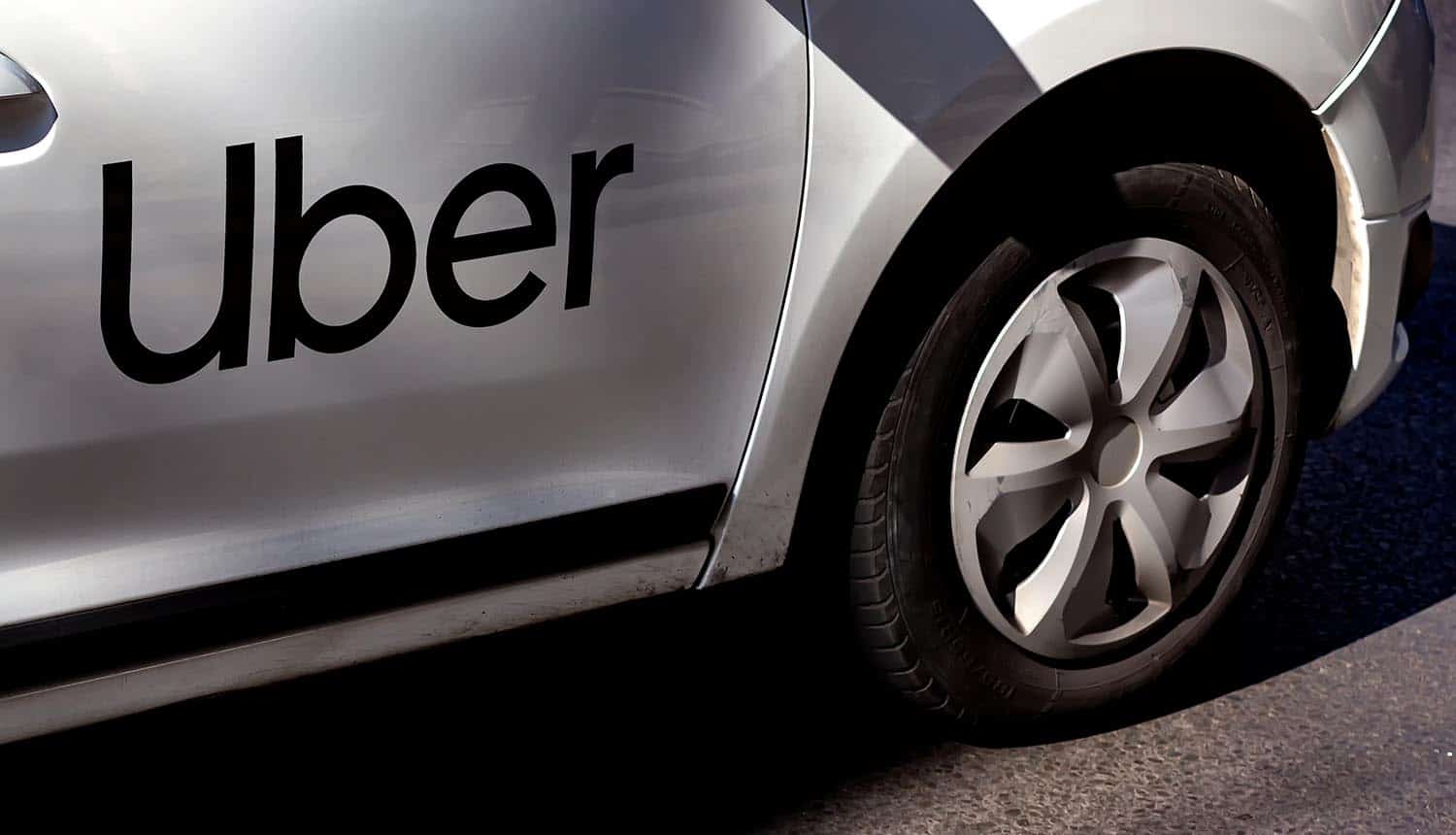 Uber logo branded car on a street showing network breach and cybersecurity incident