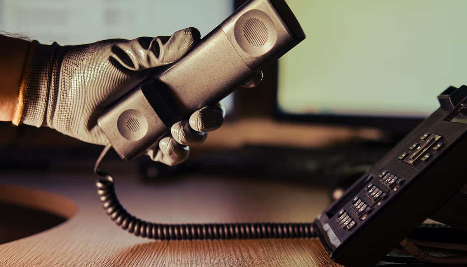 Hacker on a phone conversation showing earlier Twilio hack from vishing attack