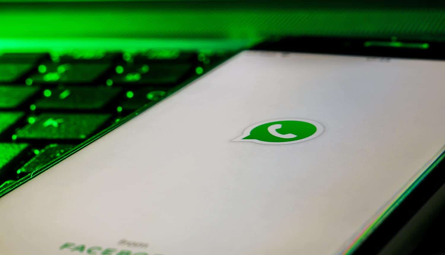Mobile phone on a computer keyboard with the WhatsApp logo showing data leak on dark web