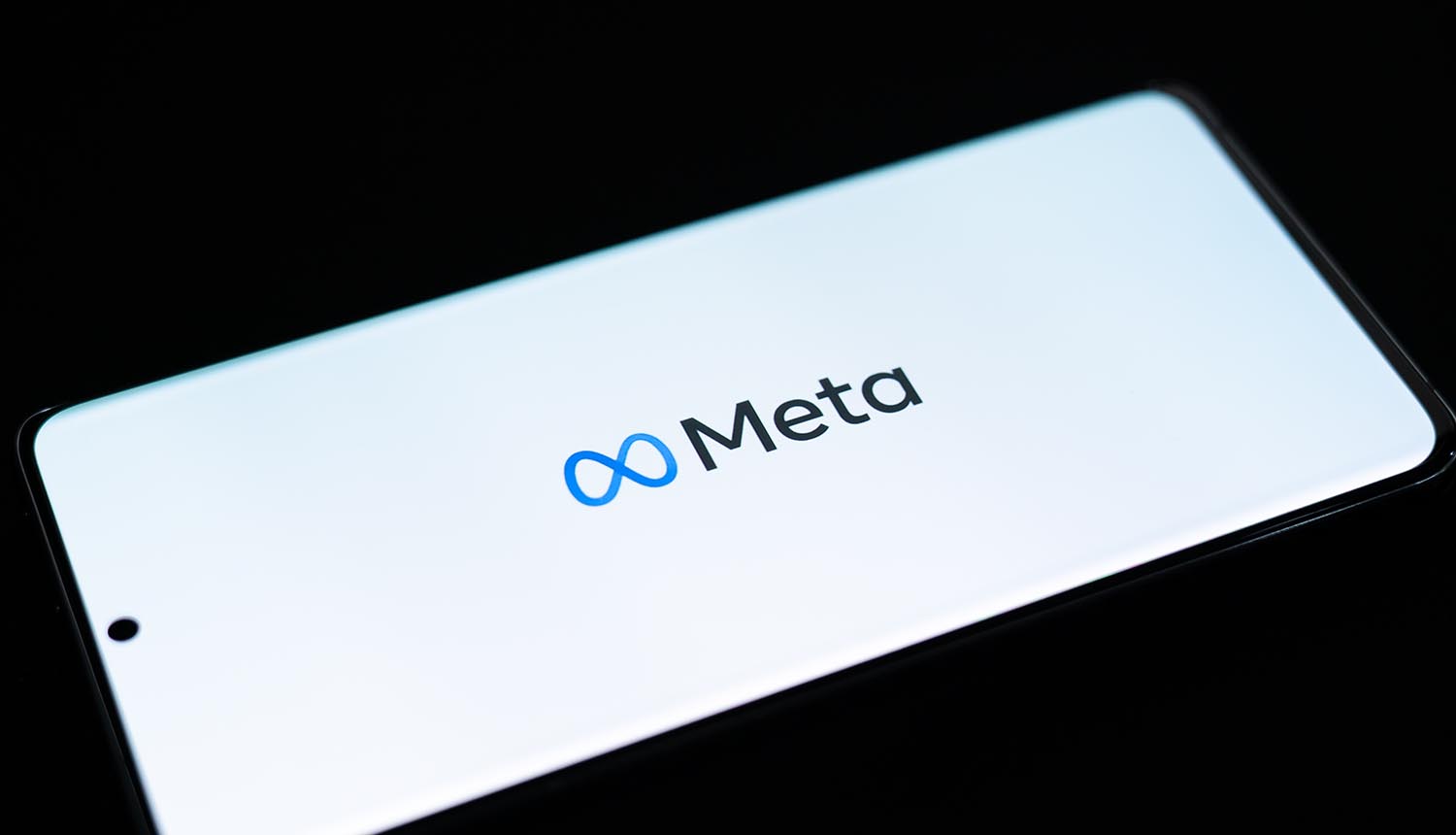 Meta logo on device screen showing account recovery tool used for account hijacking