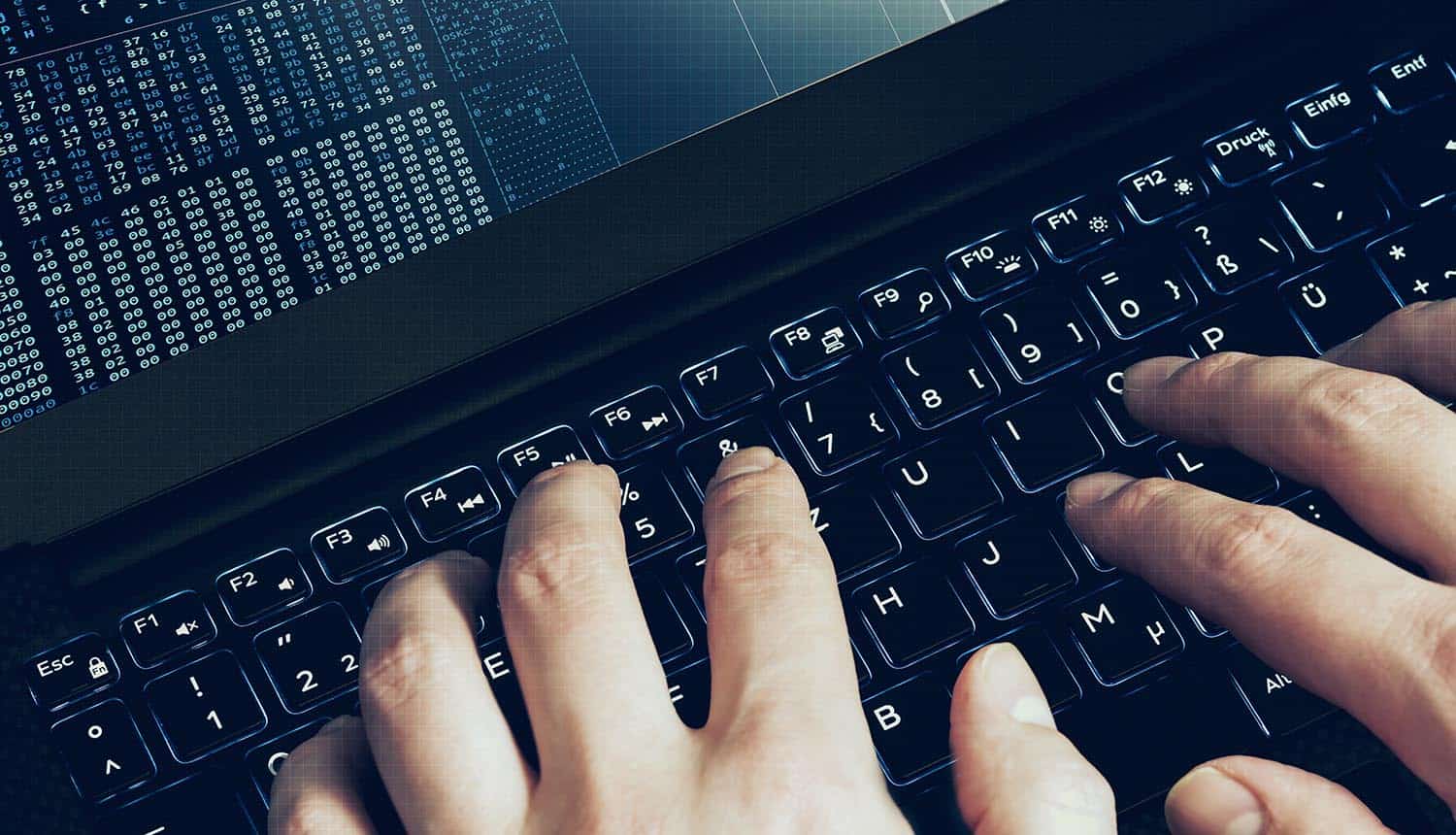 Hacker hands at work on code showing GitHub repositories hacked for Okta source code