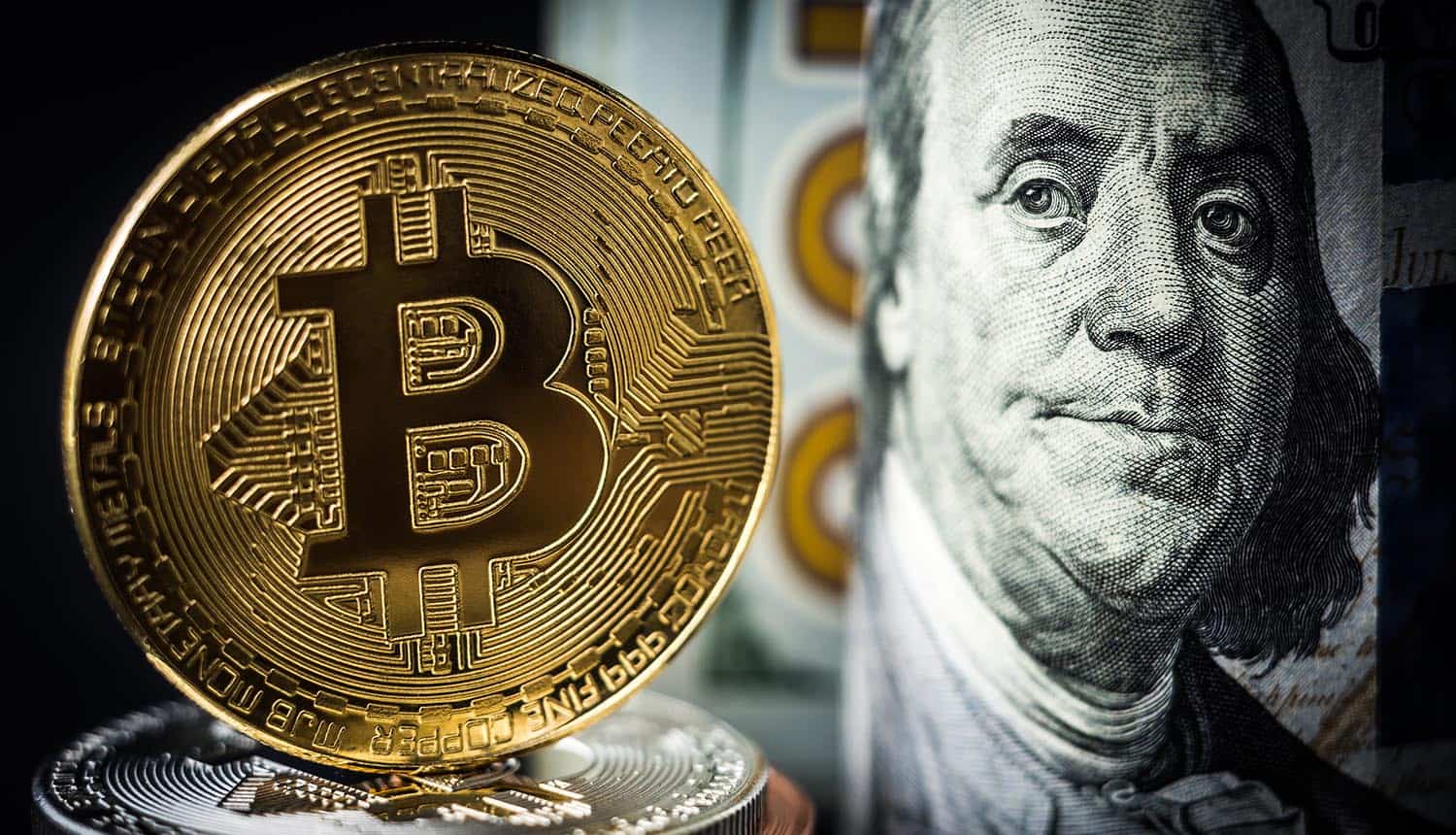 Gold bitcoin coin standing in front of dollar bills showing crypto crimes