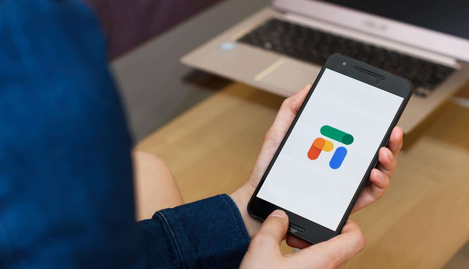 Hands holding smartphone using Google Fi service showing impact from T-Mobile data breach