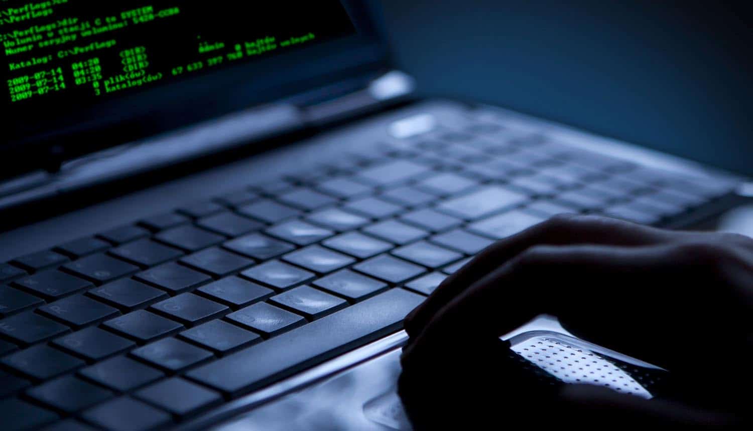 Hand on laptop in the dark showing financial service provider Latitude data breach