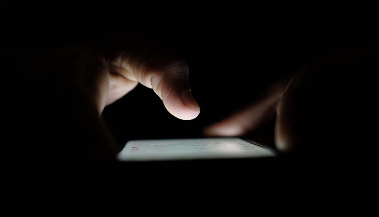 Hands over phone showing spyware
