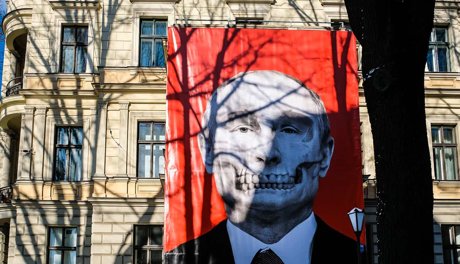 Poster of Russian President Vladimir Putin on building showing Russian cyberwar according to Vulkan Files