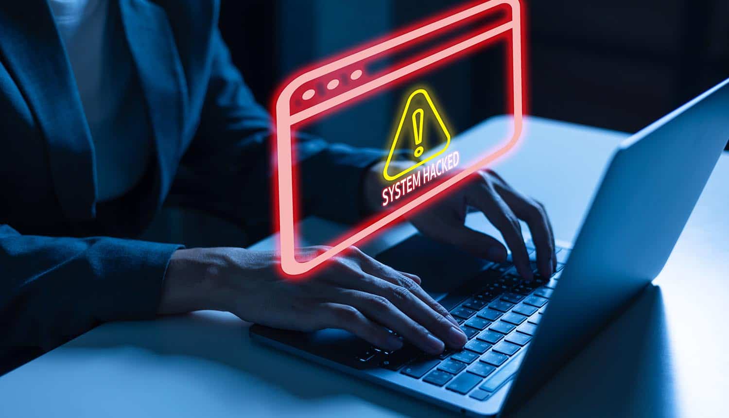 Man using a laptop with cyber attack warning showing supply chain attack