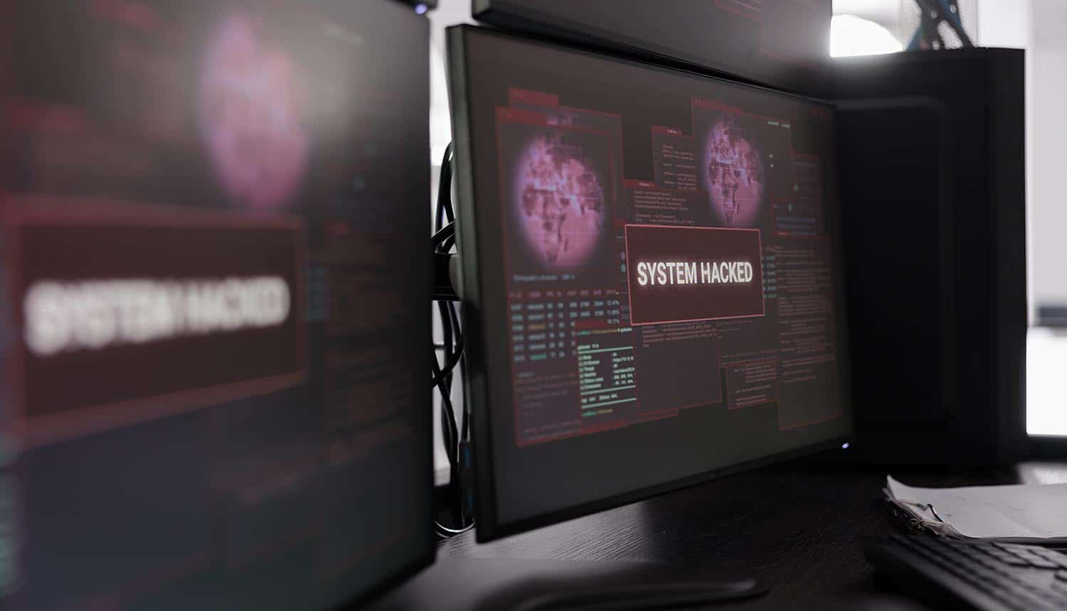 Hacked system alert message showing on monitor showing investment research firm data breach