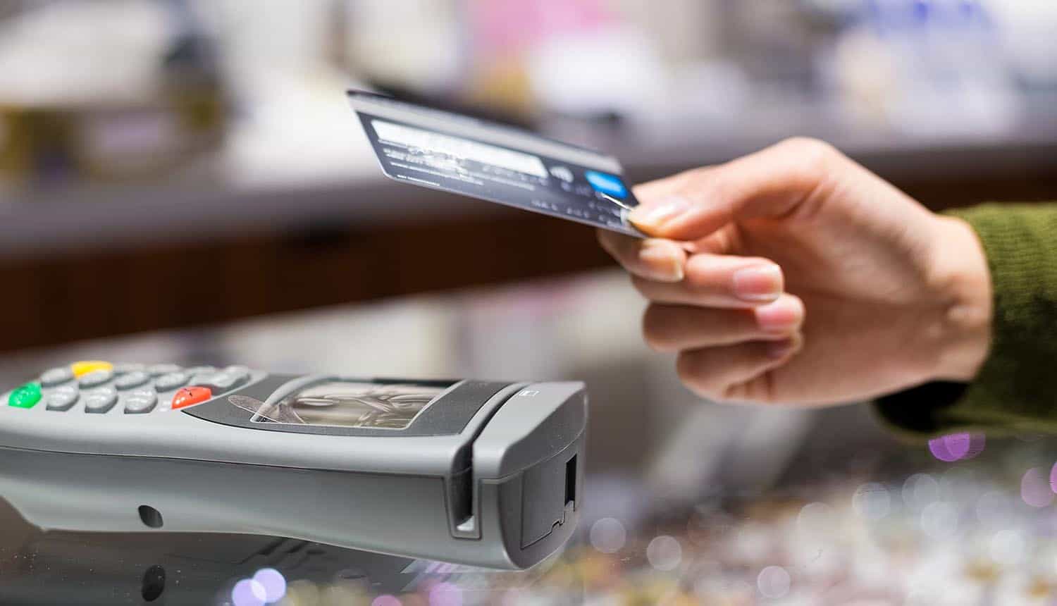 Customer paying with credit card showing cyber attack affecting payment at gas stations