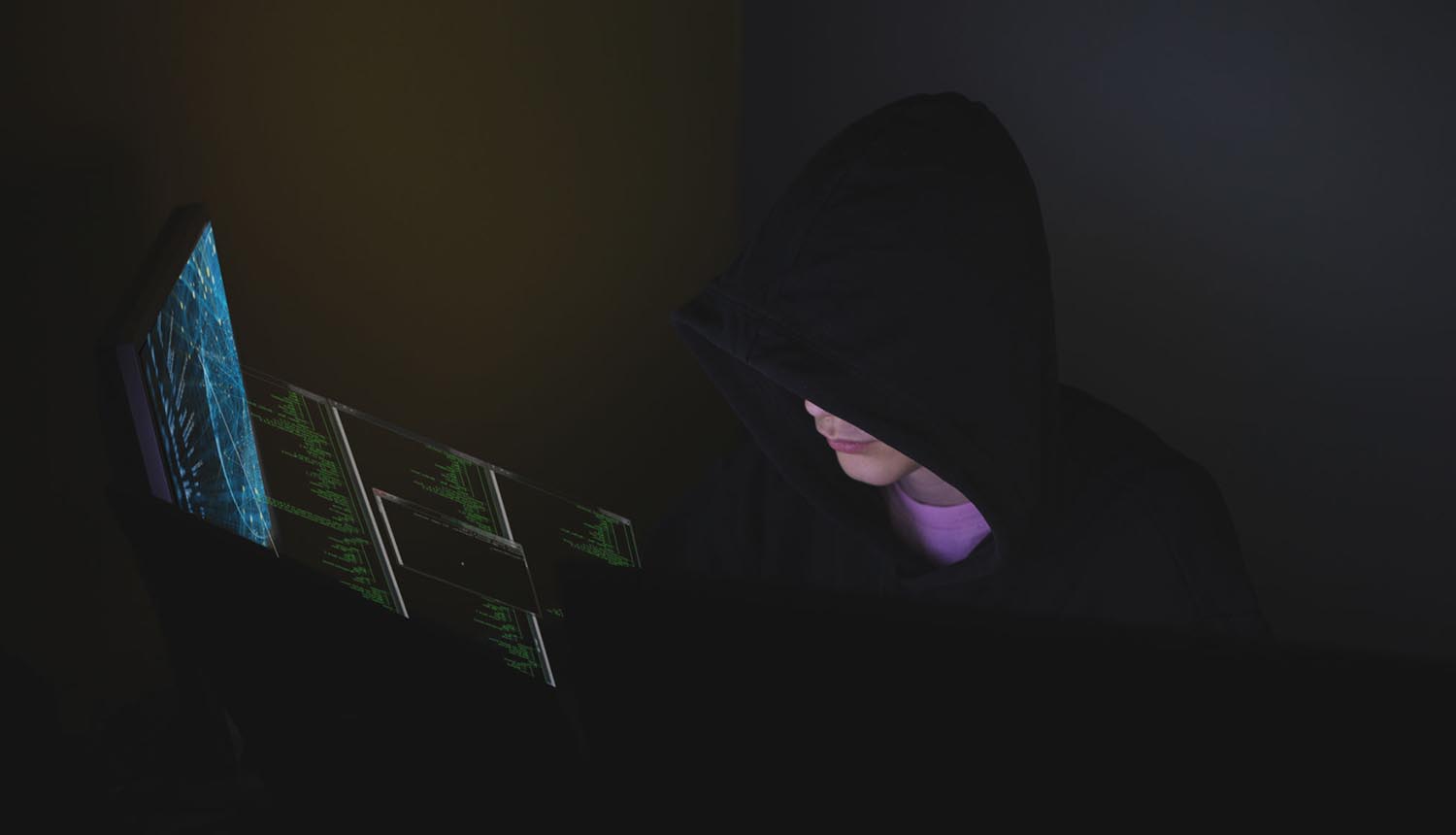 Hacker working in front of computer showing Chinese hackers exploit military networks