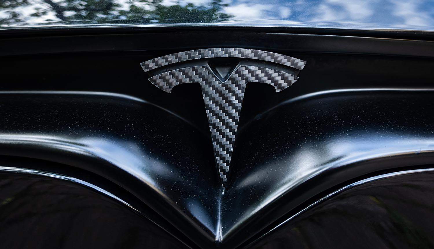 Tesla car badge showing data security concerns in China over Sentry Mode