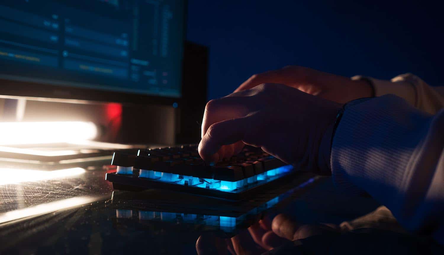 Hands typing on keyboard showing ransomware attack on largest bank