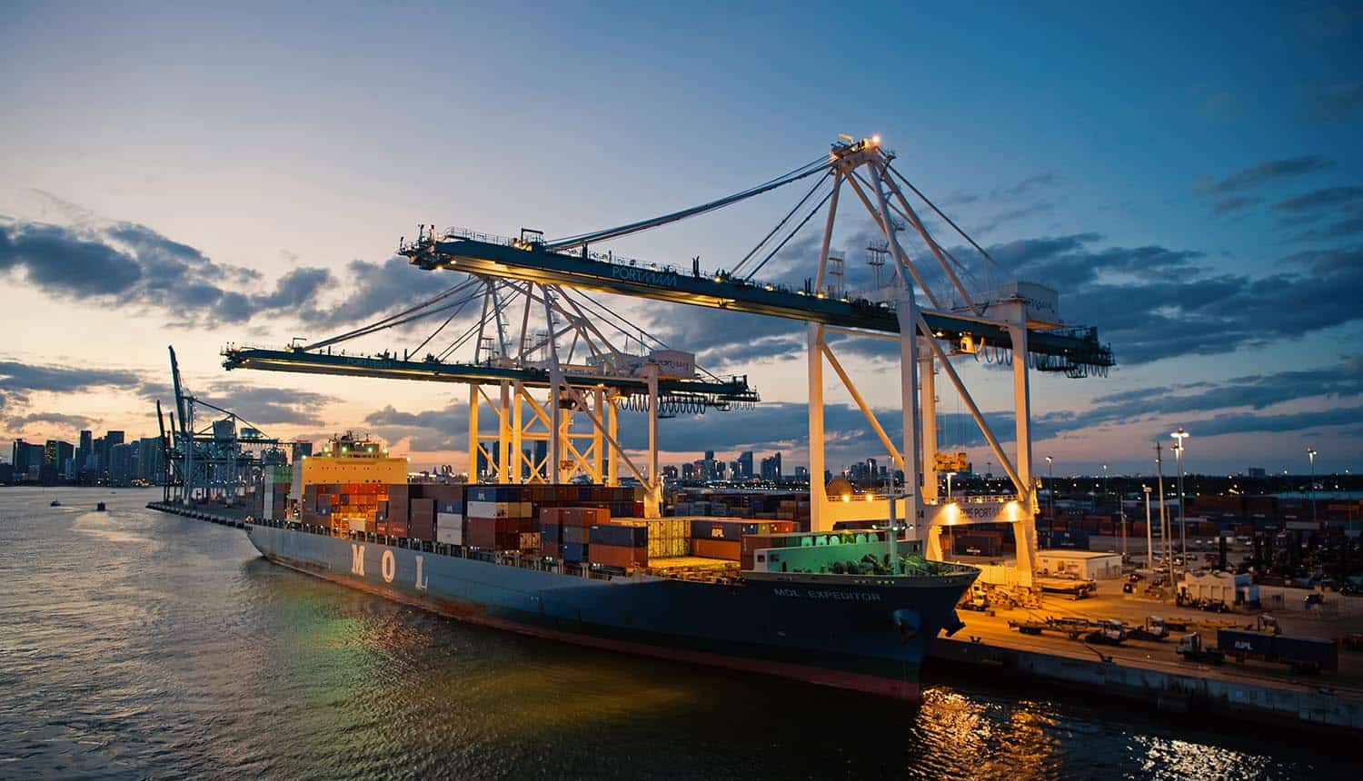 Container ship and cranes in evening showing Australia port operations impacted by cyber incident
