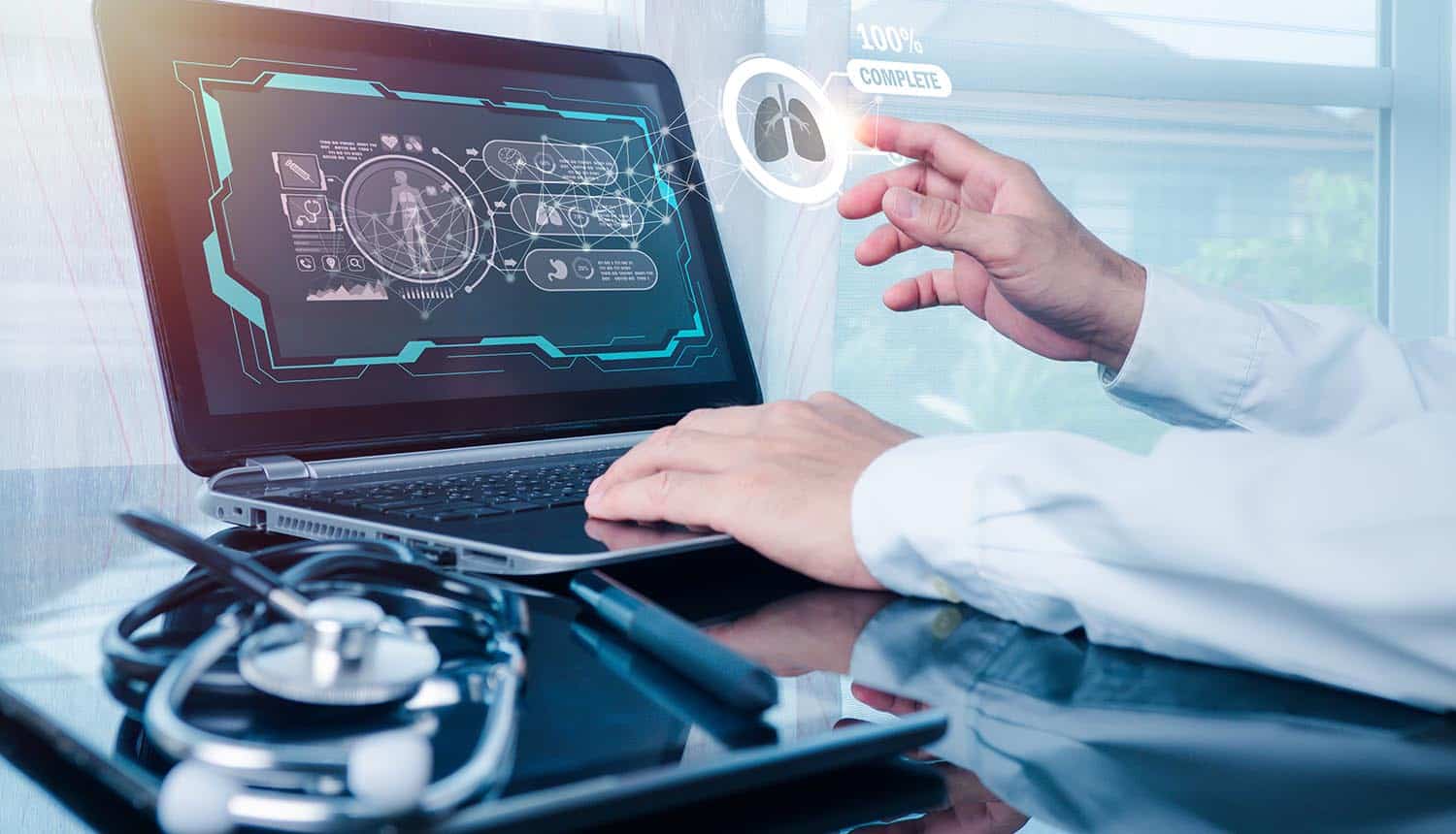 Doctor working on a laptop showing healthcare cybersecurity and cybersecurity strategy
