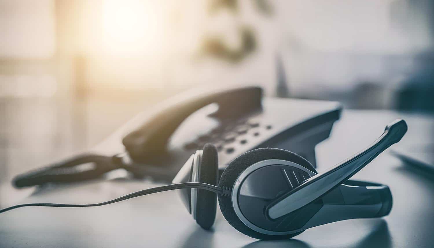 VOIP headset on laptop computer keyboard showing Okta customer support security breach