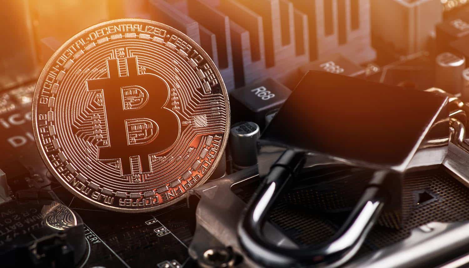 Bitcoin with padlock on motherboard showing ransomware payments