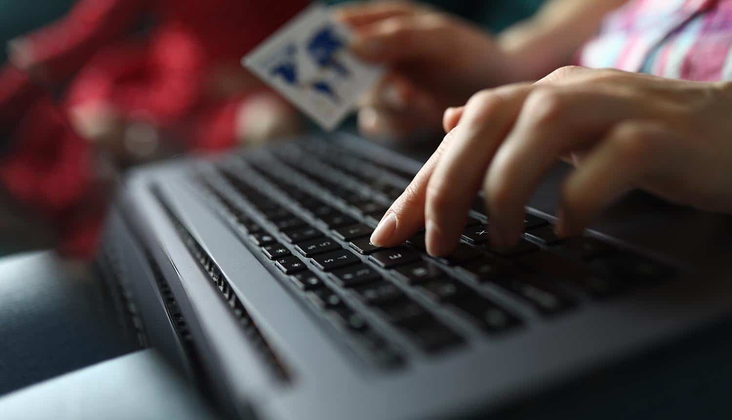 Hand holds credit card showing data breach of payment providers