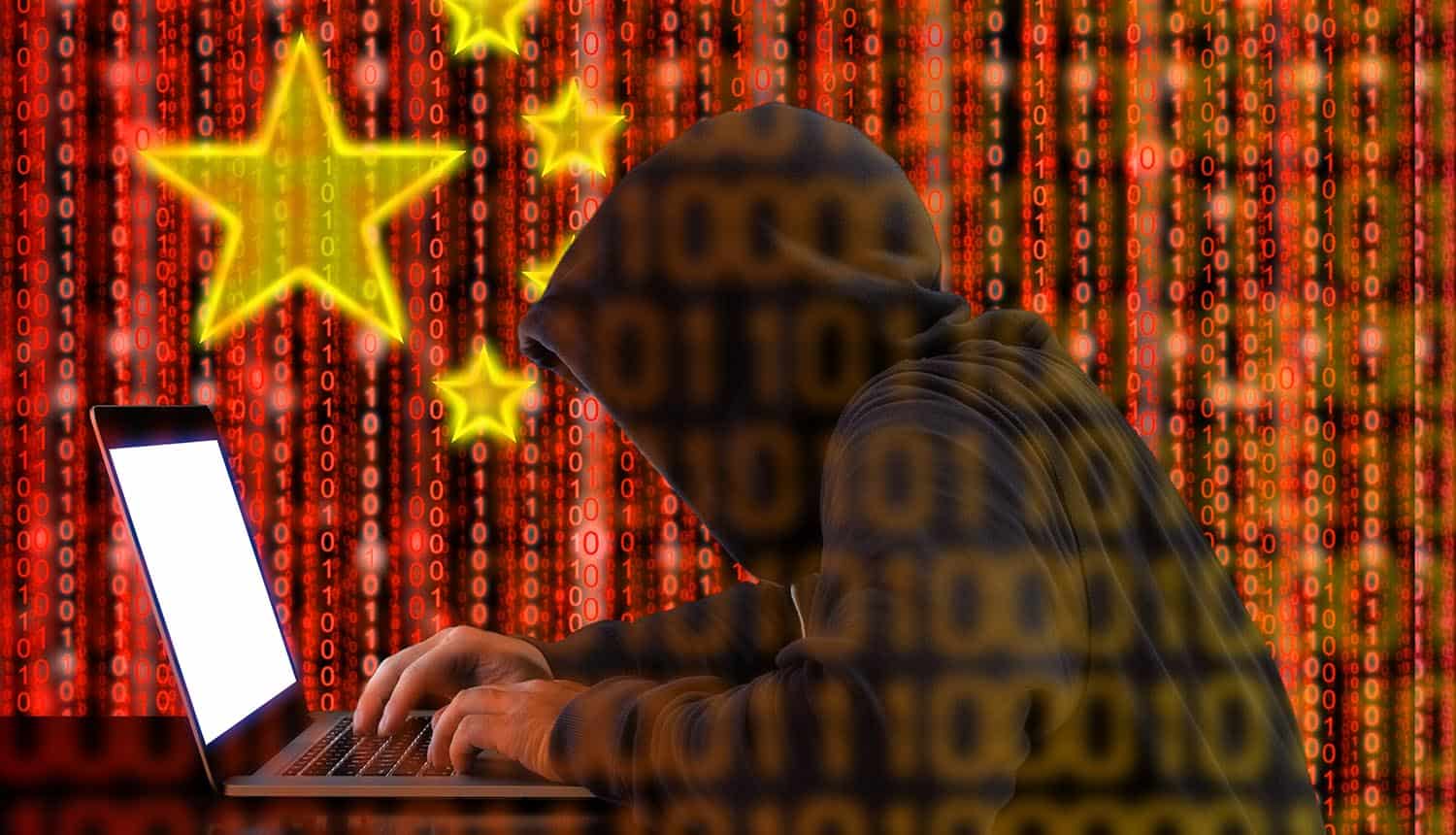 Hacker in front of laptop showing Chinese APT group attack on government organizations