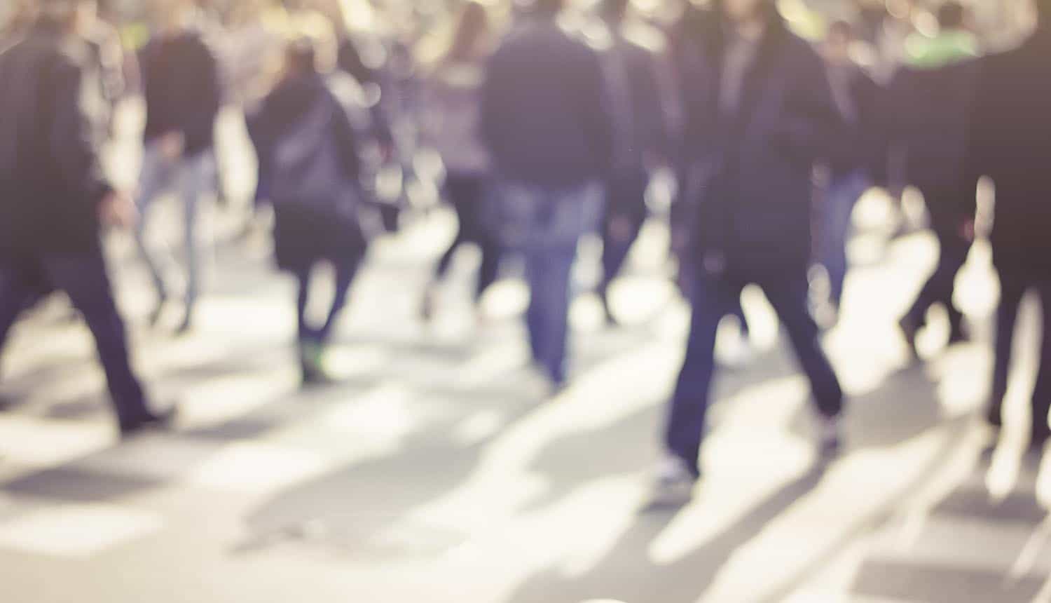 Pedestrians in city street showing data breach at France unemployment agency