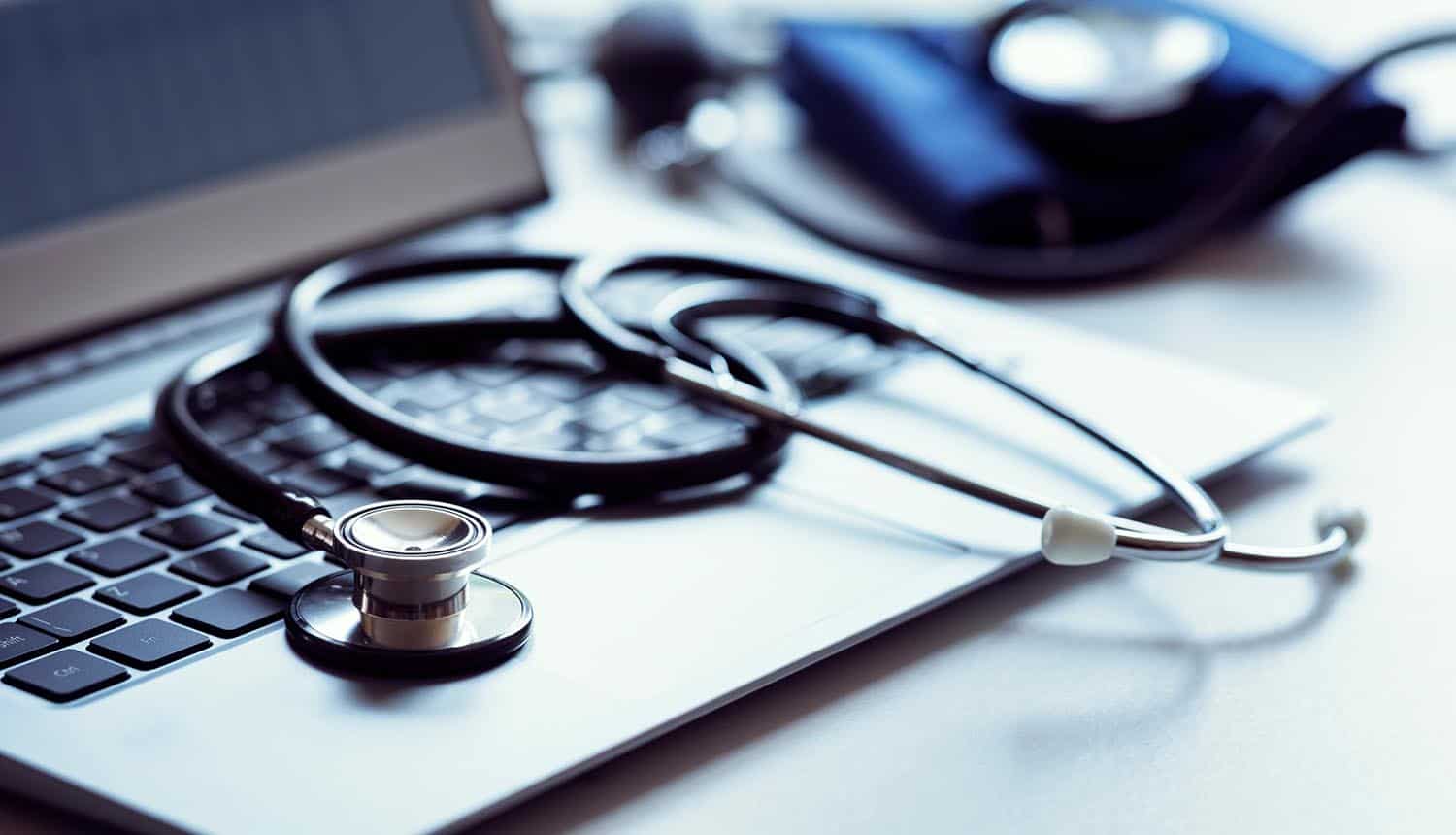 Stethoscope on laptop keyboard showing Change Healthcare ransom payment and stolen patient data