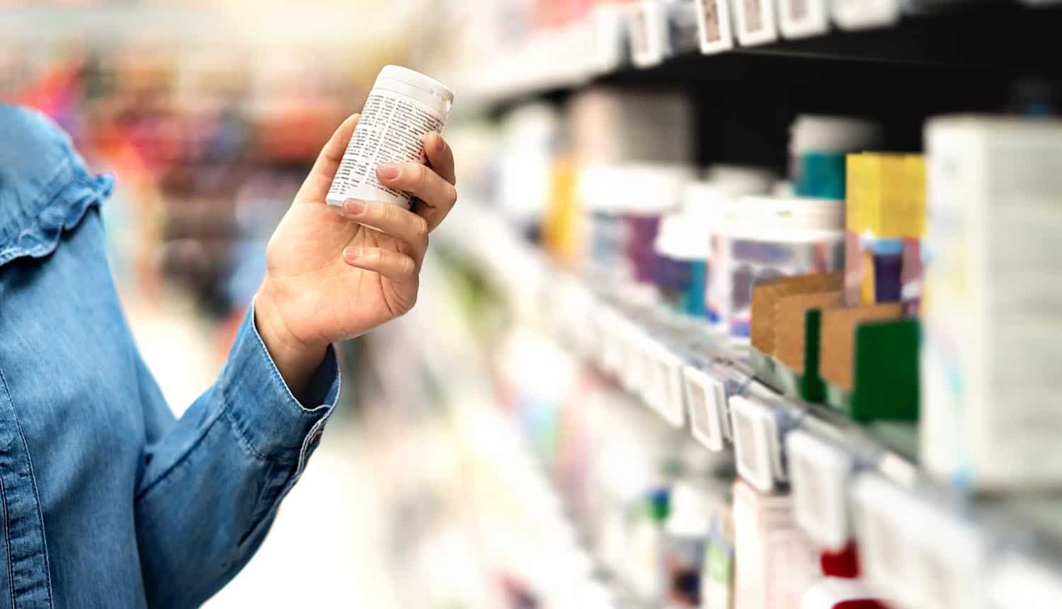 Woman holding medicine bottle showing data breach at MediSecure