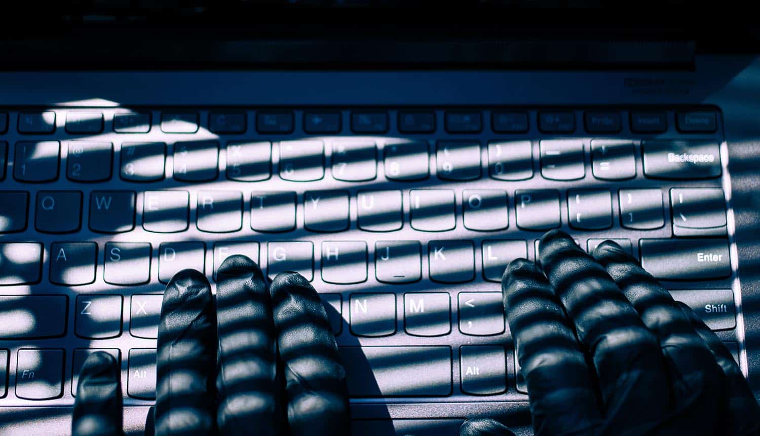 Hand typing on keyboard showing fake tax refunds
