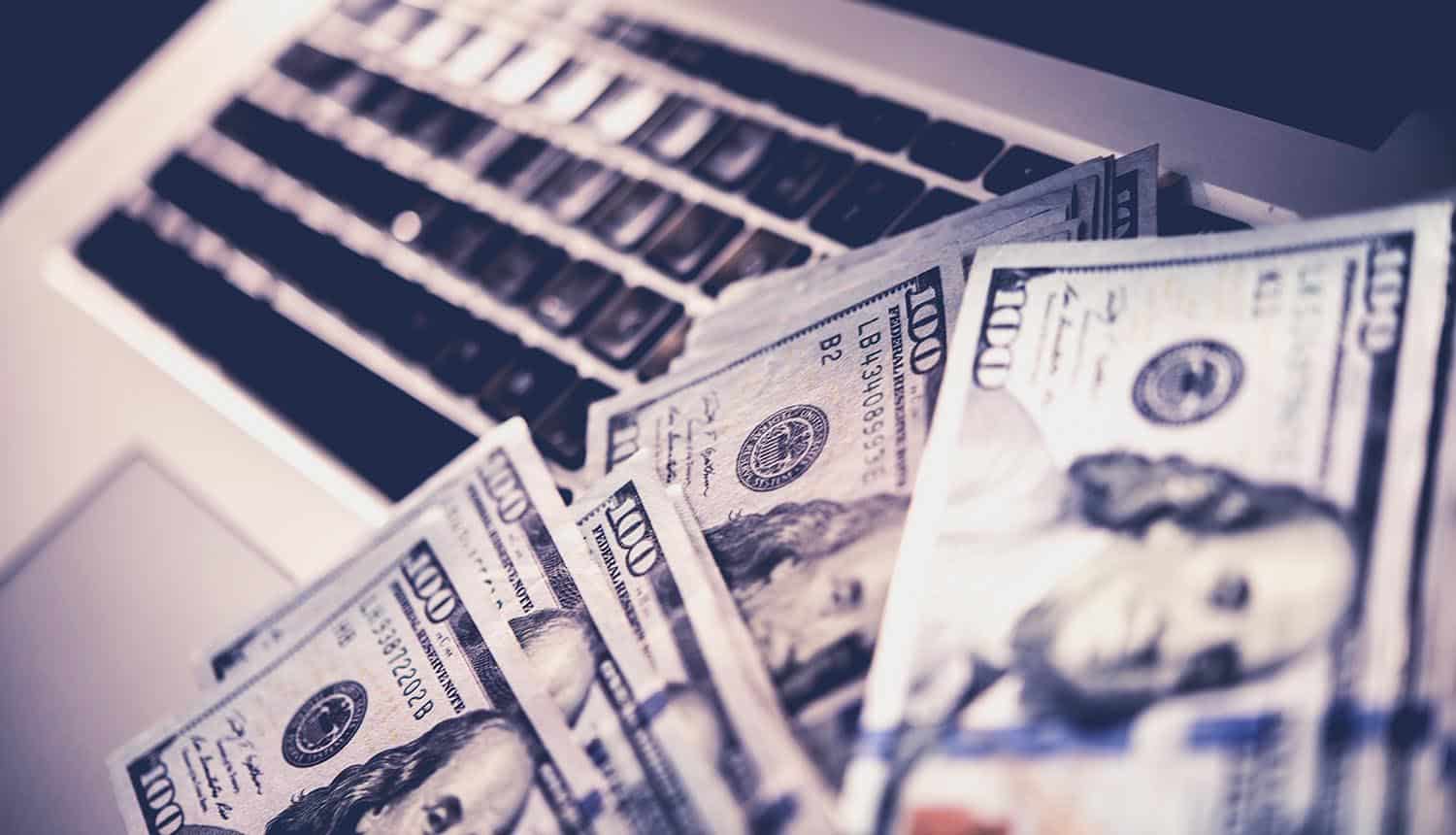 Dollar notes on laptop showing DocuSign APIs abused for fake invoices