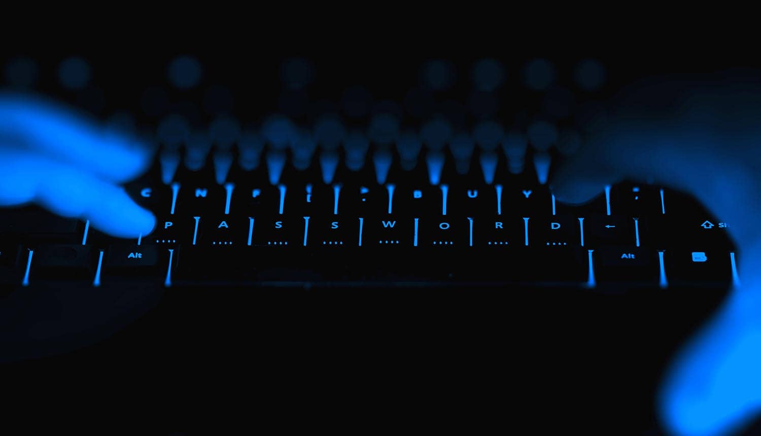 Hacker typing on keyboard showing security breach at U.S. bank regulator