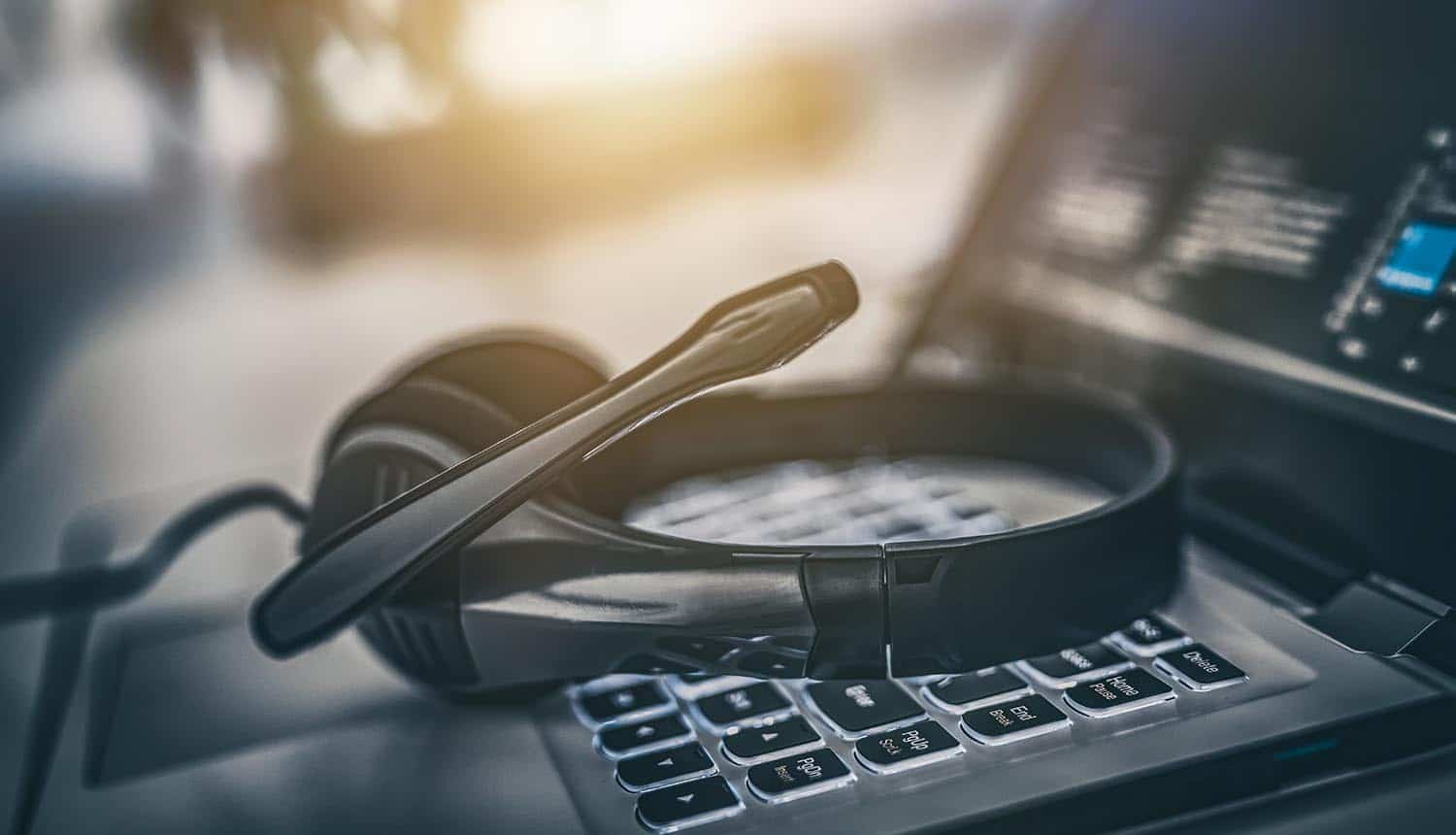 Headset on keyboard showing social engineering of IT help desks
