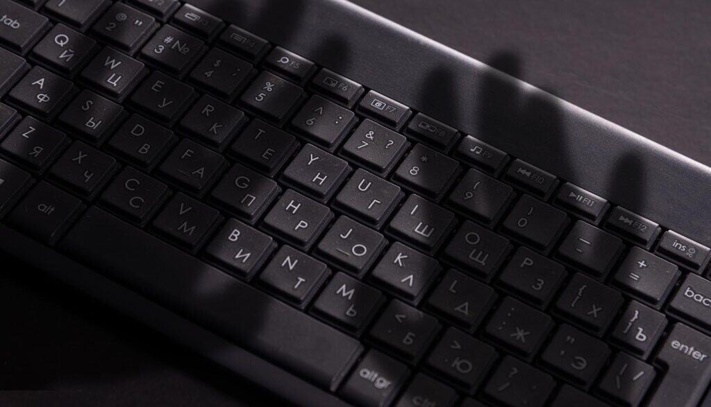 Dark shadow of hand on keyboard showing data theft with Copilot vulnerability