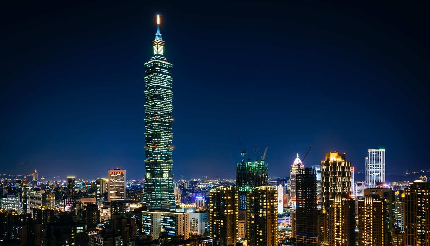 Taipei skyline at night showing autonomous AI cyber attack