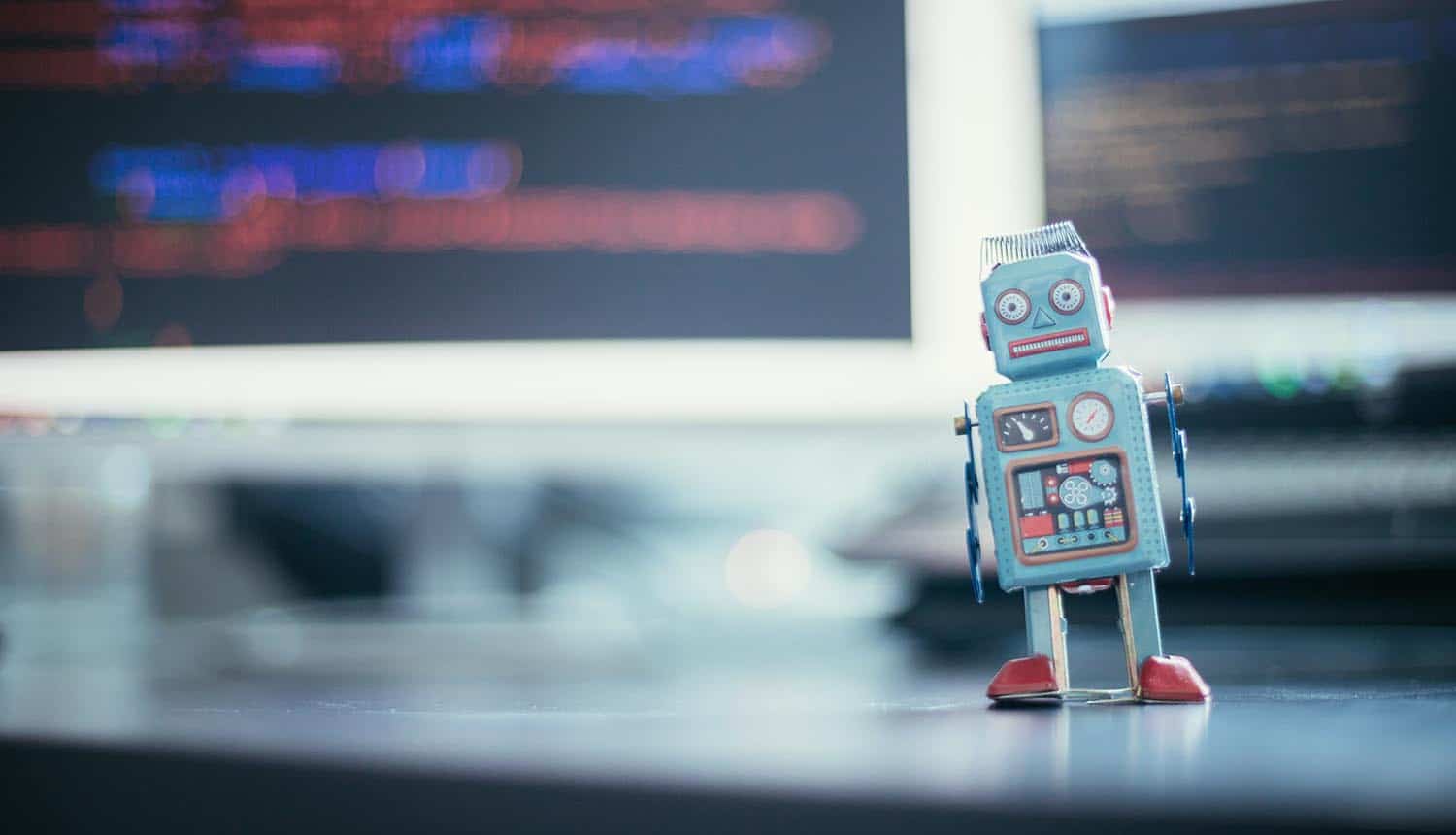 Robot in front of monitor showing AI models hacking